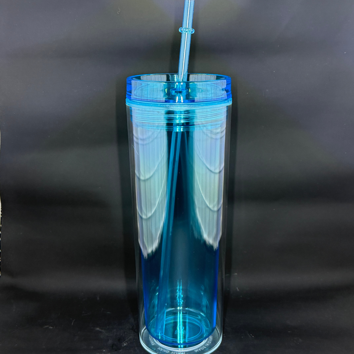 A 16oz light blue acrylic skinny tumbler with a matching lid and straw against a black background.