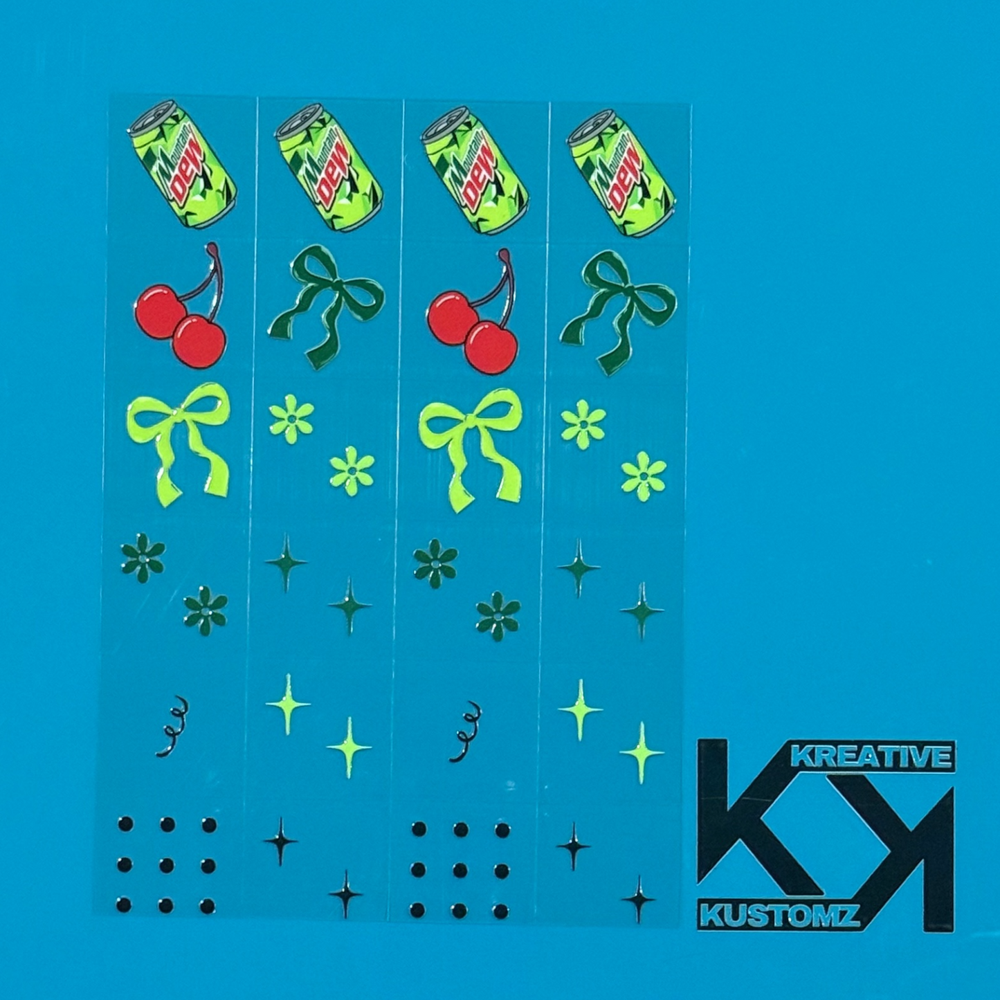 An A5 sheet of precut UV DTF decals featuring Mountain Dew cans, cherries, bows, and floral icons.