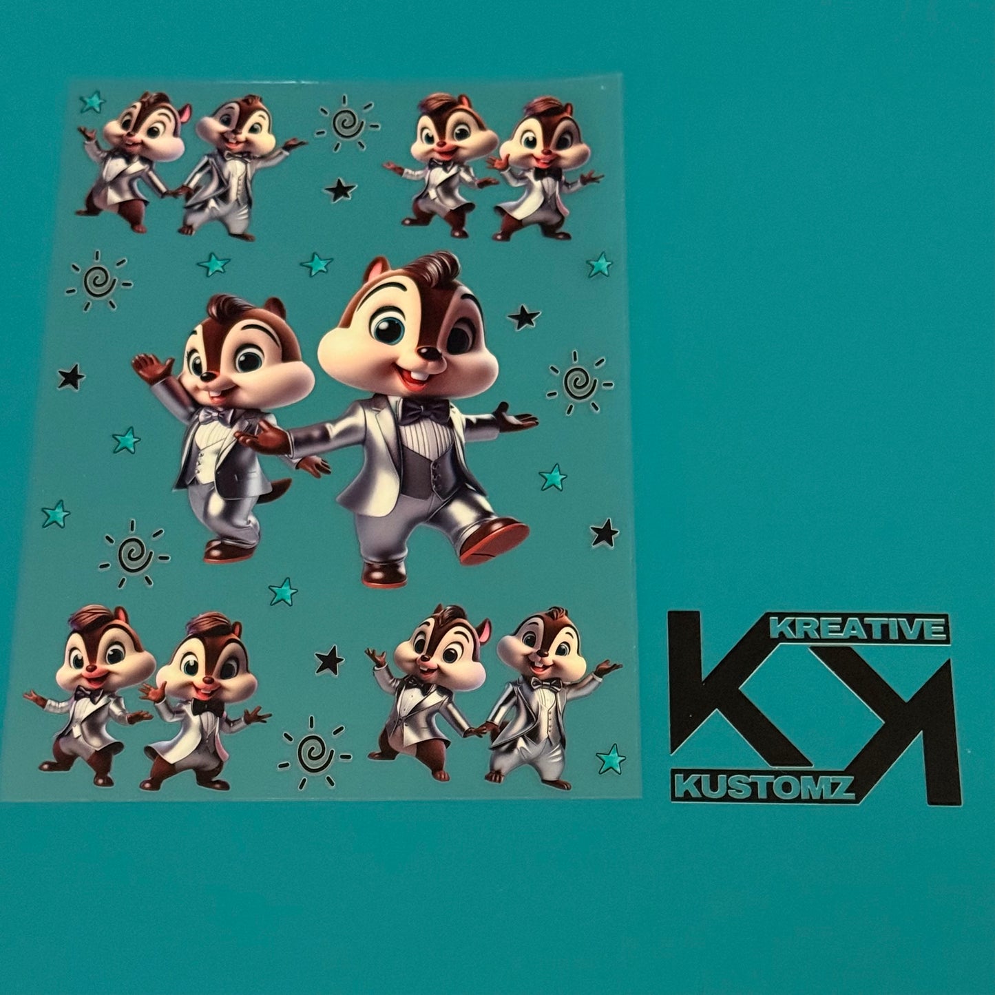 An A5 sheet of UV-DTF decals featuring cartoon chipmunks in silver tuxedos with stars and suns.
