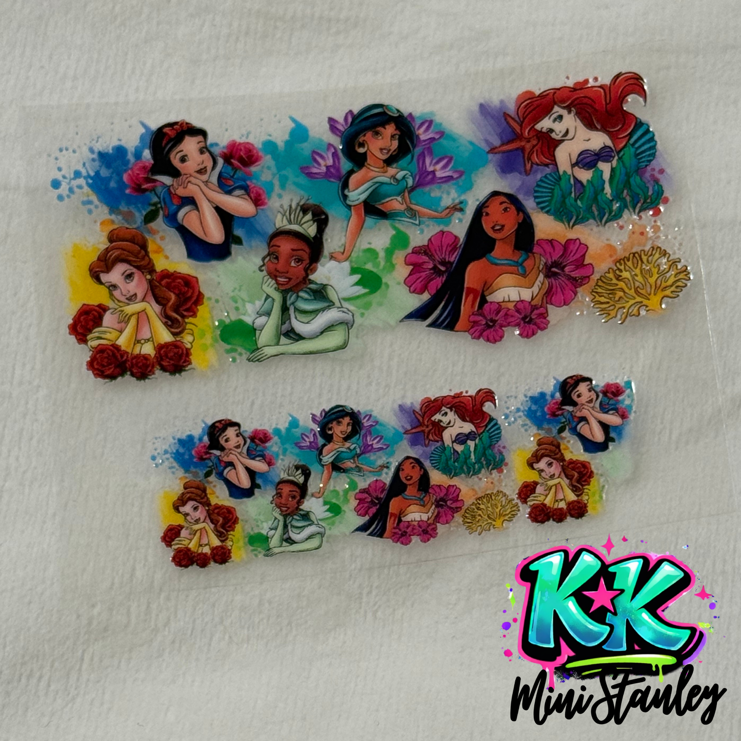 Two UV DTF adhesive wraps featuring Disney princesses with floral accents for mini keychain cups.