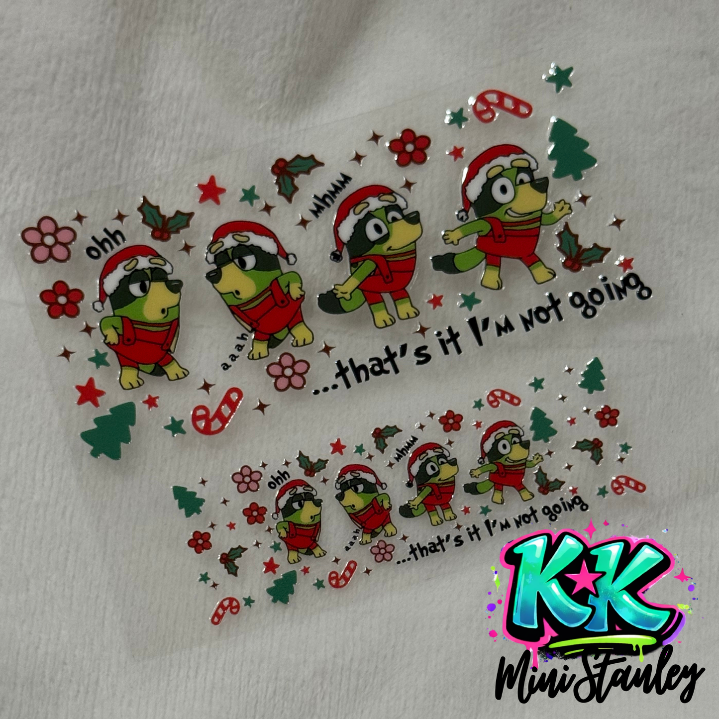 Two UV DTF adhesive wraps featuring a Christmas-themed cartoon dog and holiday icons.