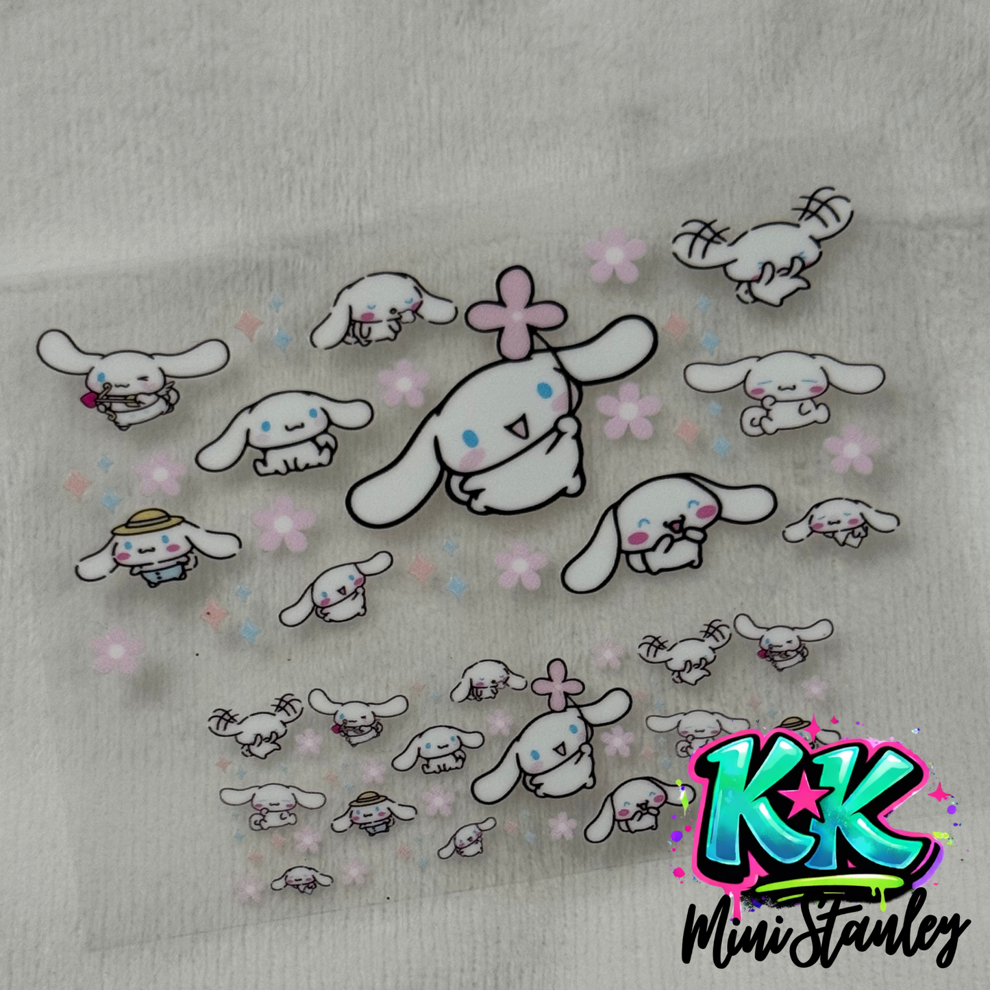 A UV DTF adhesive decal sheet featuring Cinnamoroll characters and pink flowers.