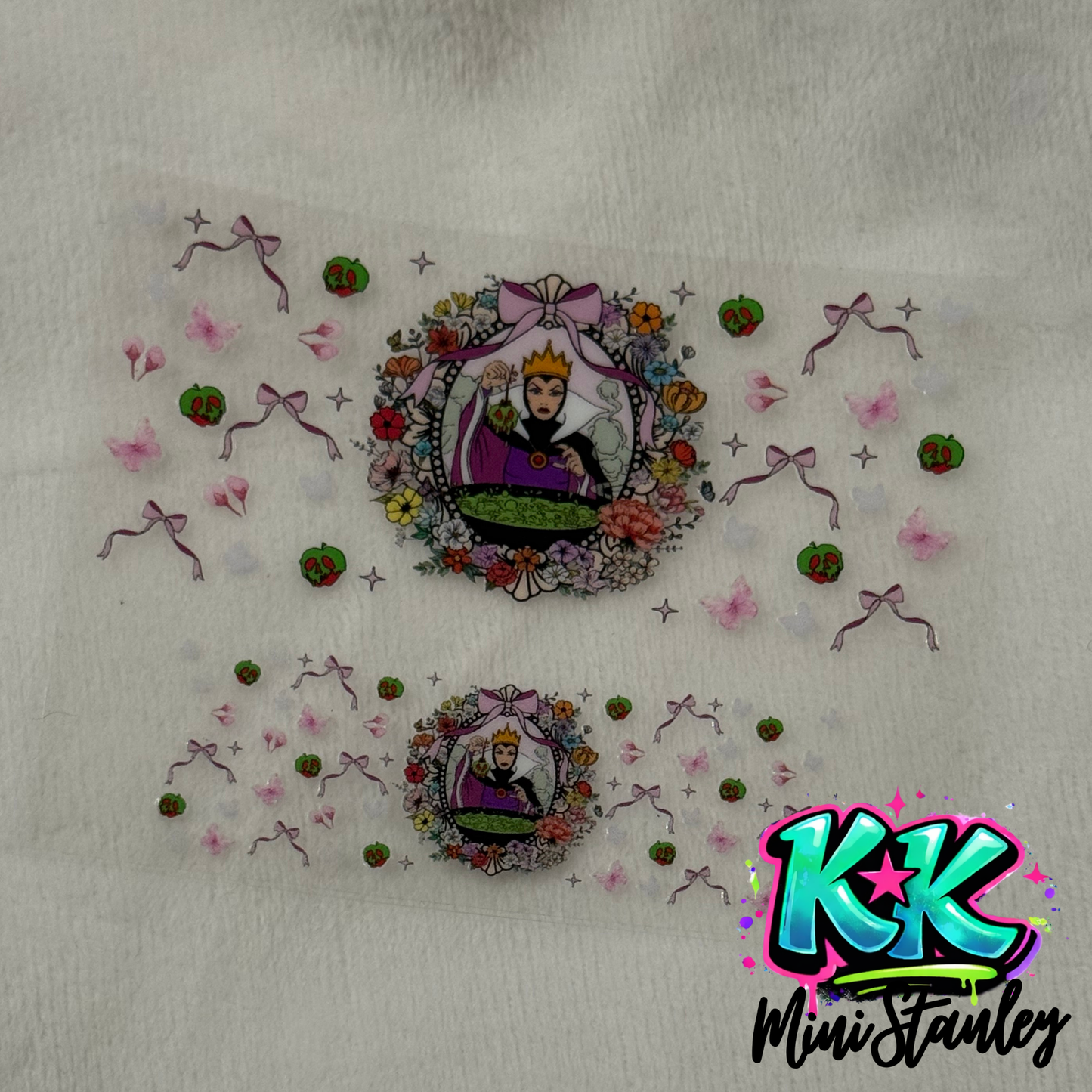 Two UV DTF adhesive decals featuring the Evil Queen surrounded by flowers, bows, and apples.