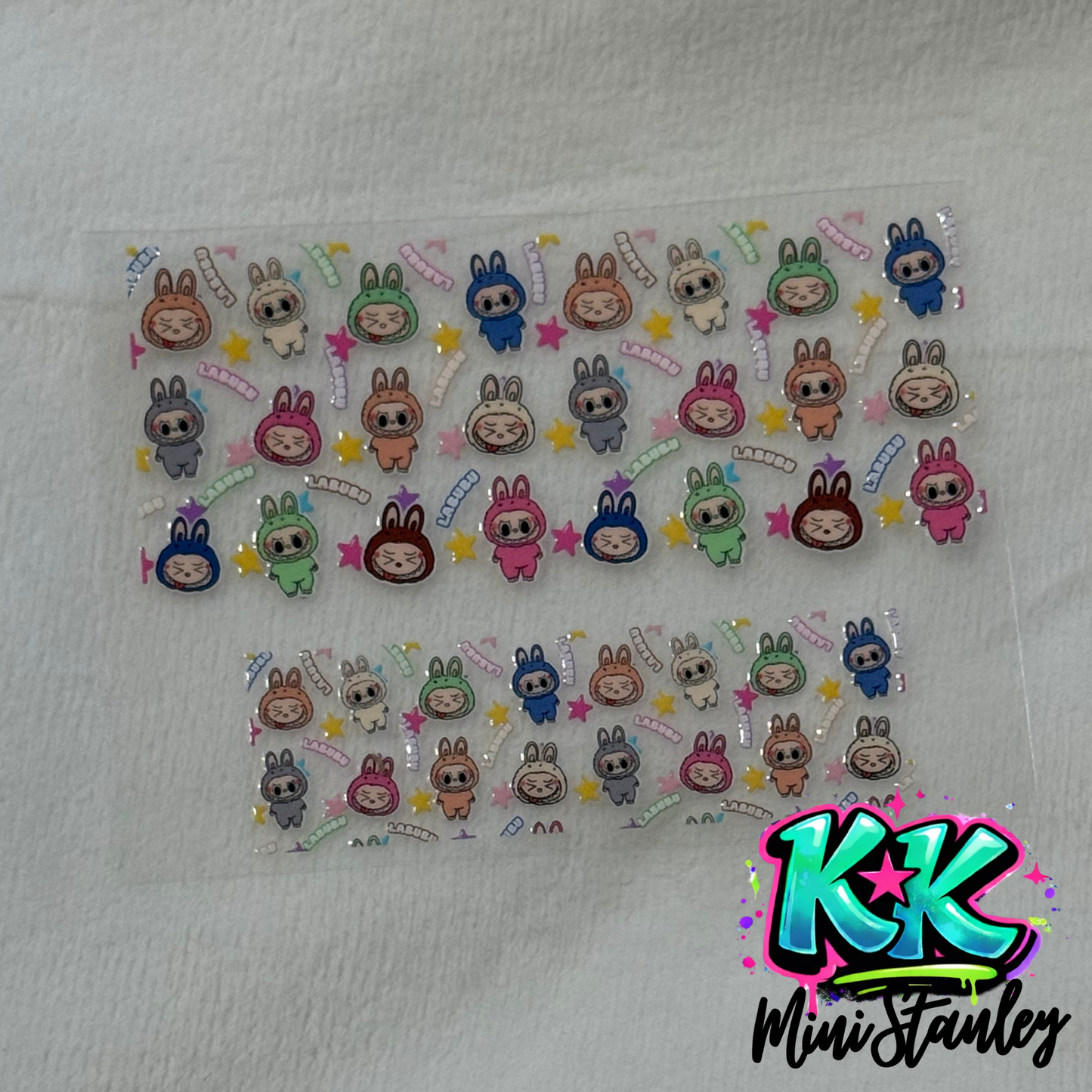 Two sheets of UV DTF adhesive decals featuring colorful Labubu character designs.