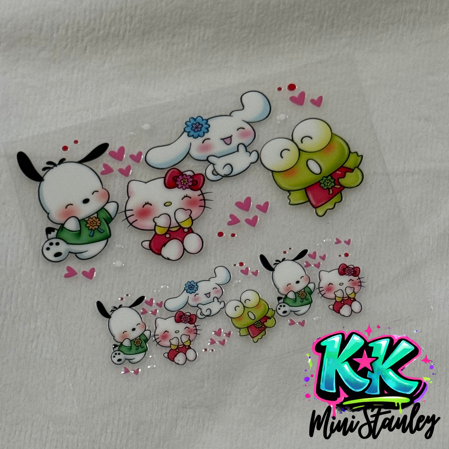A UV DTF adhesive wrap featuring Sanrio characters like Hello Kitty for a mini keychain cup.