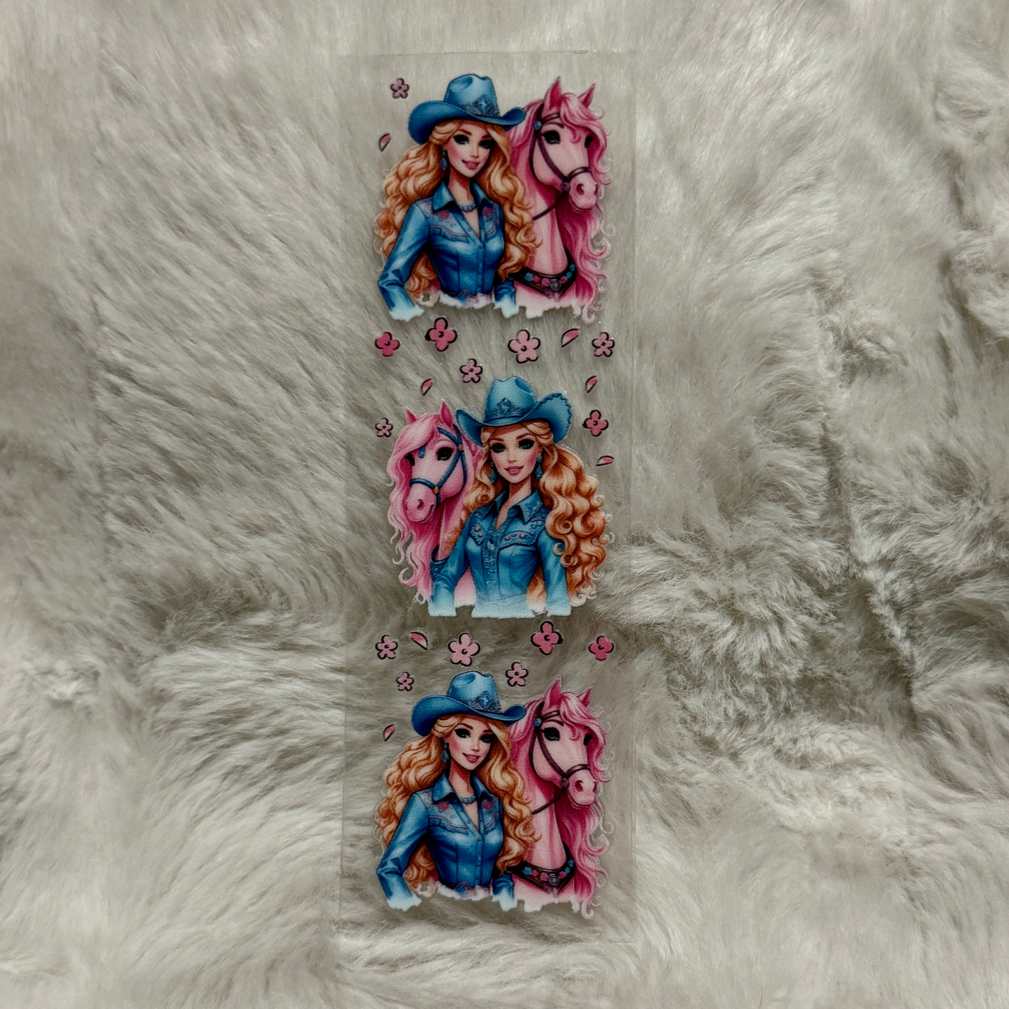 A UV DTF adhesive pen wrap featuring three repeating illustrations of a cowgirl and a pink horse.