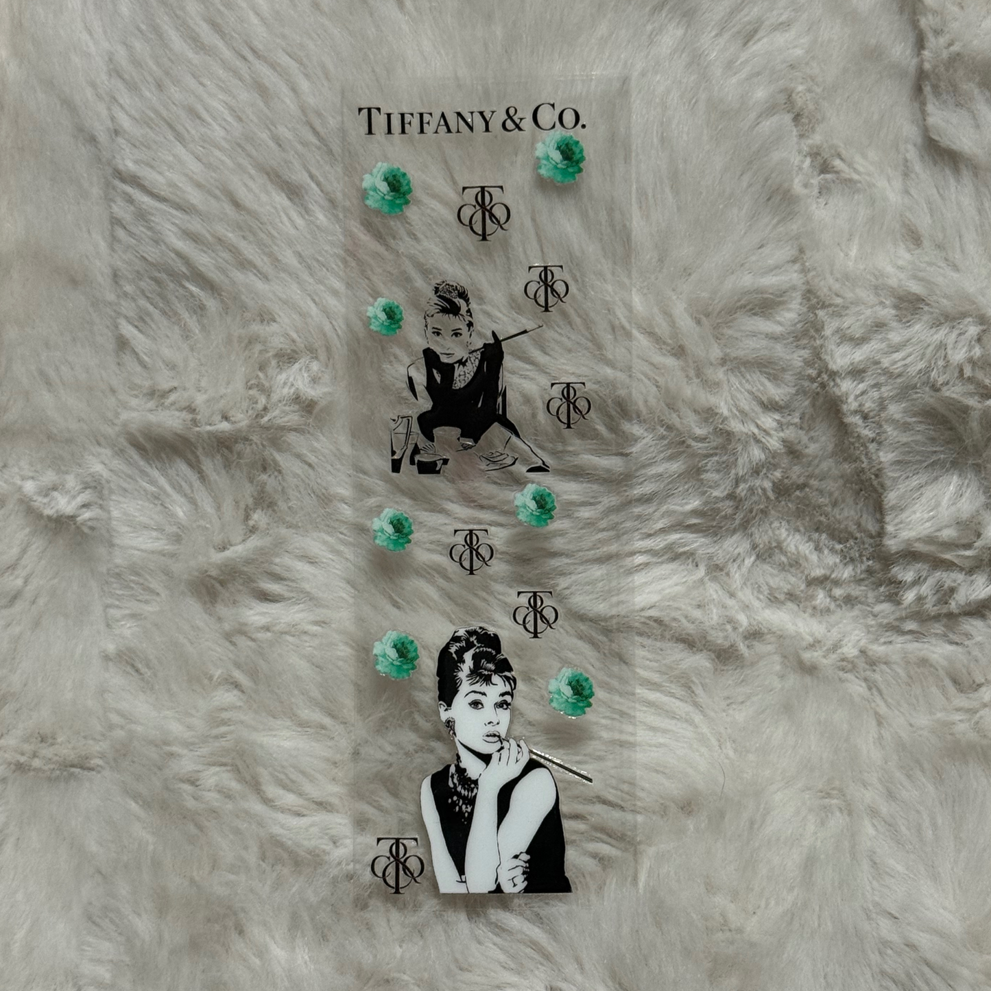 A clear UV DTF pen wrap featuring Audrey Hepburn, Tiffany and Co branding, and teal floral accents.