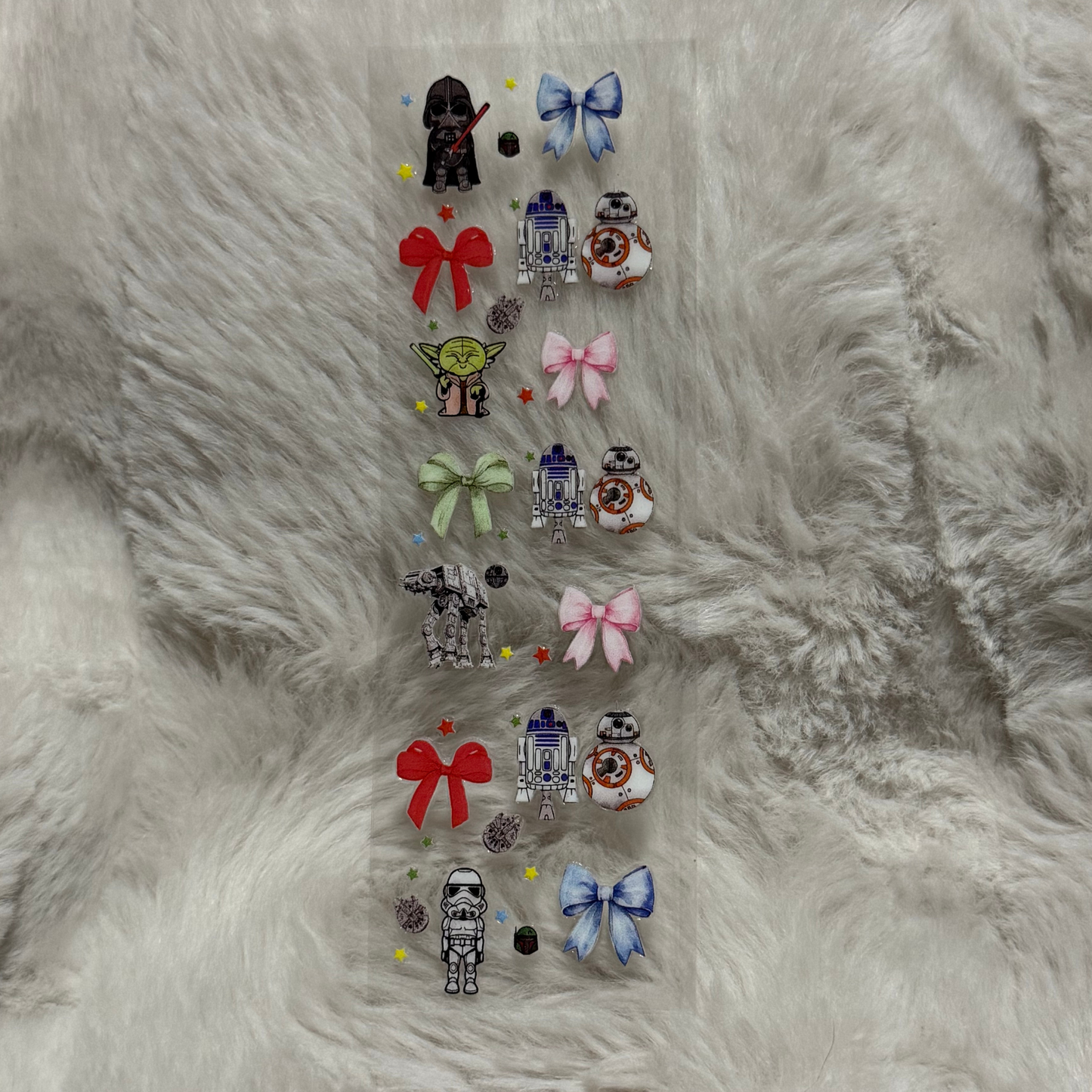 A rectangular sheet of Star Wars themed UV DTF stickers featuring characters and bows.