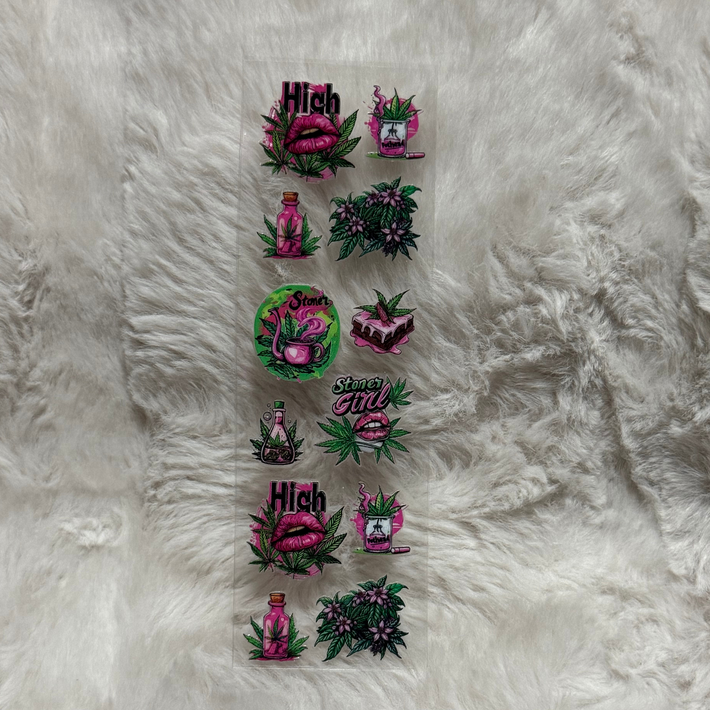 A sheet of UV DTF adhesive pen wraps featuring pink lips, cannabis leaves, and potion designs.