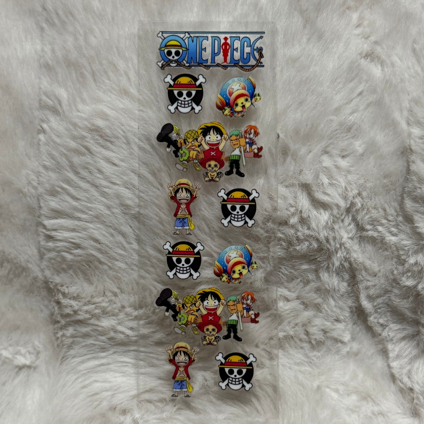 A rectangular UV DTF adhesive pen wrap featuring One Piece character and logo designs.