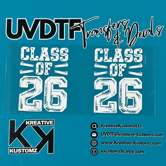 Two white Class of 26 UV DTF adhesive transfers for glass cups on a teal background.