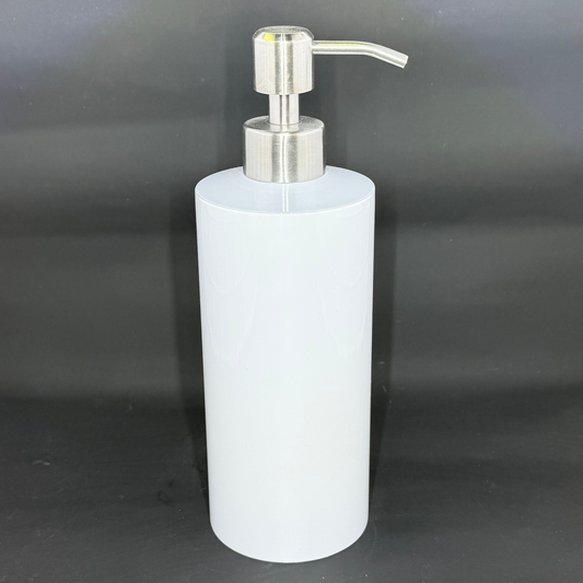 A white cylindrical soap dispenser with a silver pump mechanism against a black background.