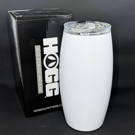 A white 25oz barrel-shaped sublimation tumbler stands next to its black HOGG branded box.