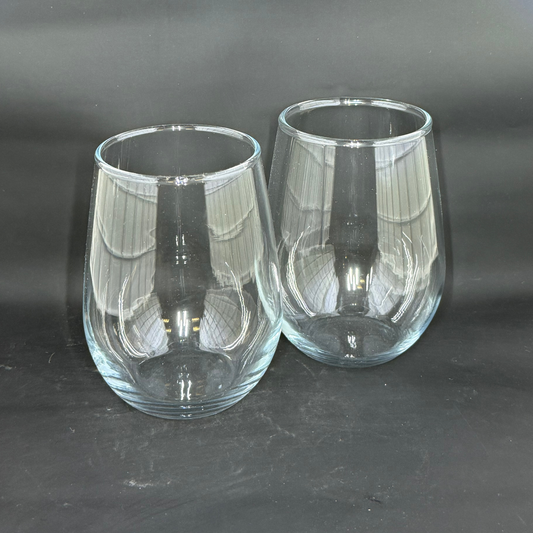Two clear 12oz stemless wine glasses sit side by side against a dark background.