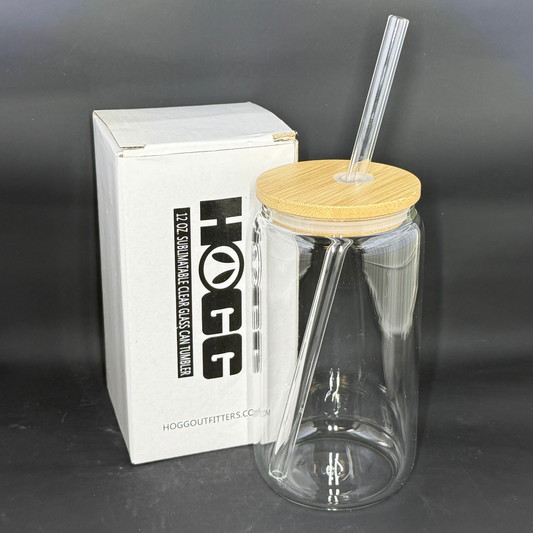 A 12oz clear glass can tumbler with a wooden lid and glass straw next to its white box.