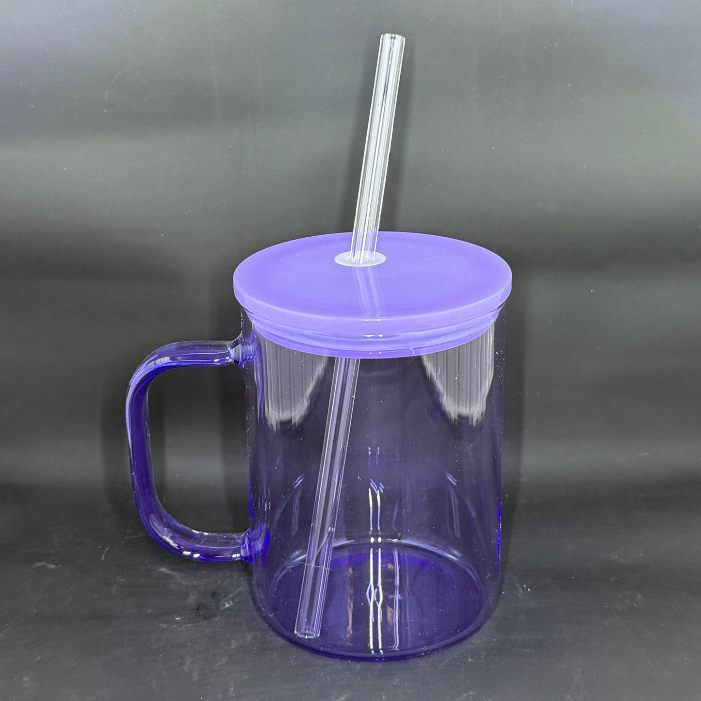 A translucent purple glass mug with a matching lid and clear straw against a black background.