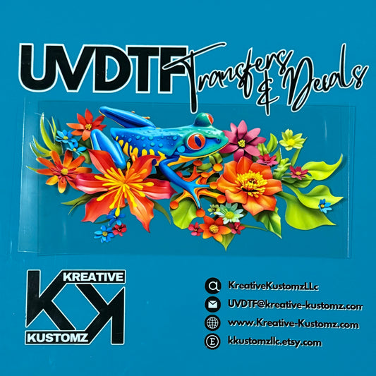 A UV DTF cup wrap featuring a blue frog surrounded by vibrant tropical flowers on a clear sheet.