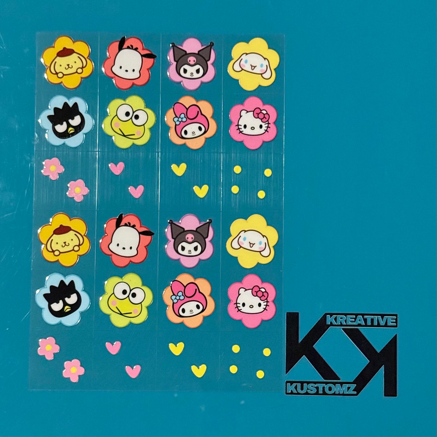 An A5 sheet of 24 precut UV DTF decals featuring Sanrio characters in colorful flower frames.