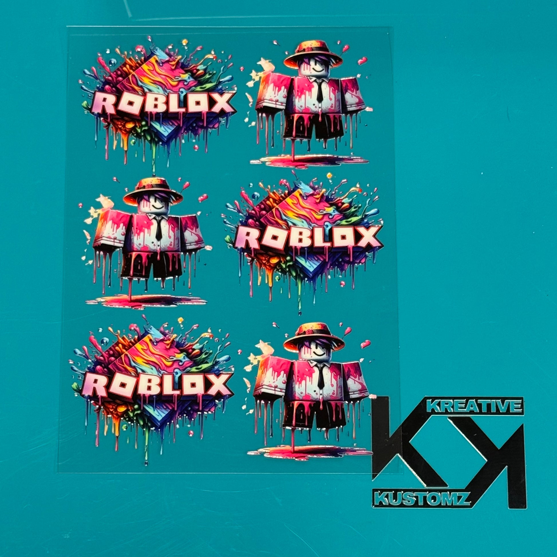 A sheet of Roblox-themed UV DTF decals featuring character and logo designs on a clear backing.