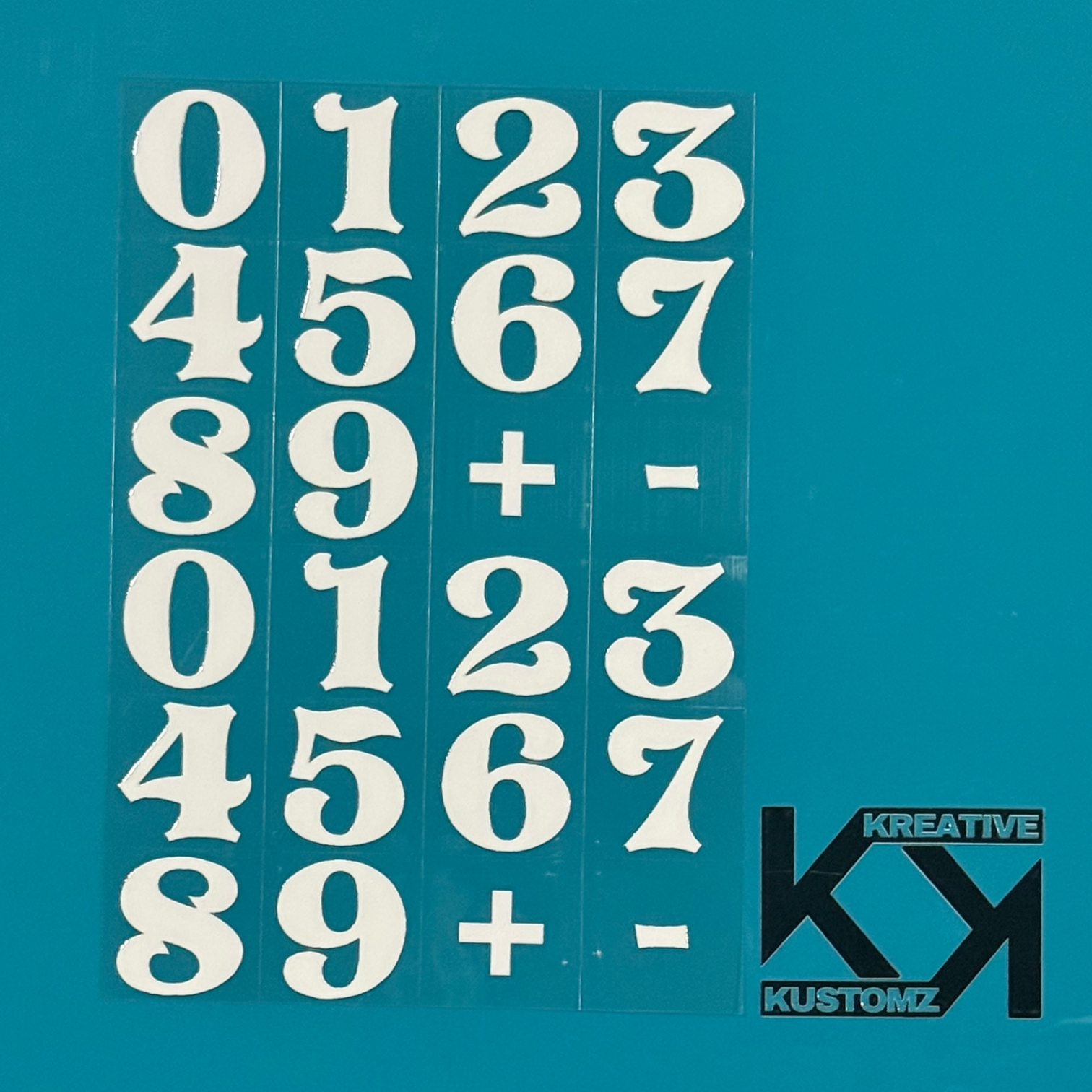 An A5 sheet of white UV DTF decals featuring two sets of numbers zero through nine plus symbols.