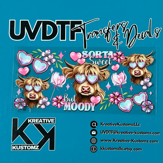 A UV DTF cup wrap featuring highland cows wearing heart-shaped glasses and floral accents.