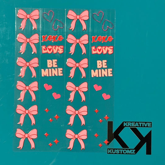 An A5 sheet of pink bow, heart, and Valentine-themed UV DTF decals on a teal background.