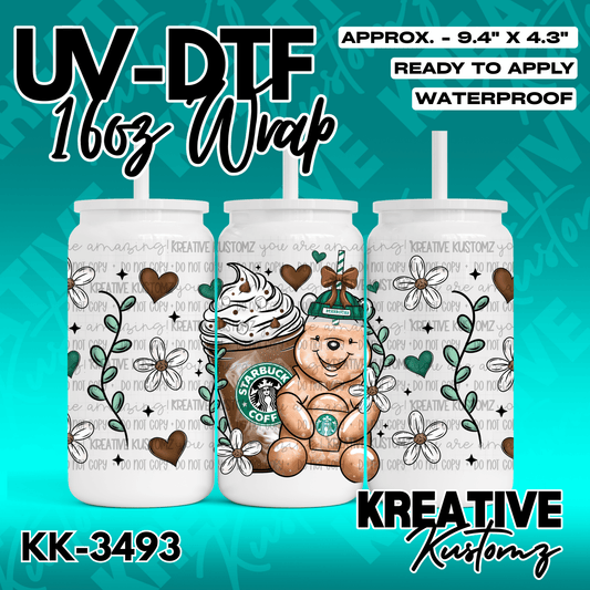 A UV DTF cup wrap featuring a teddy bear with a coffee drink, flowers, and hearts.