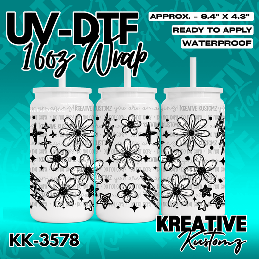 A black and white floral and lightning bolt pattern UV DTF adhesive wrap for a glass cup.