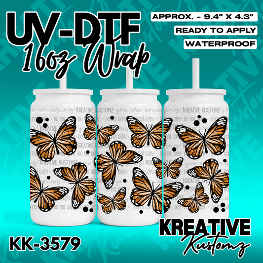 A UV DTF decal wrap for a 16oz glass can featuring a pattern of orange monarch butterflies.