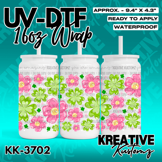 A UV DTF adhesive wrap for 16oz glass cans featuring a pattern of pink flowers and green clovers.