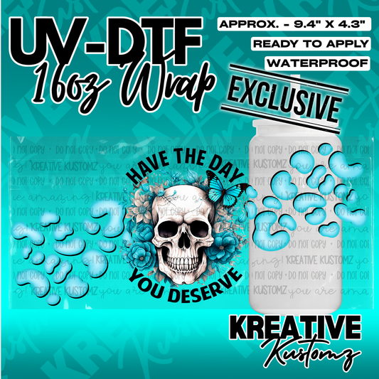 A UV DTF cup wrap featuring a skull surrounded by blue flowers and butterflies on a teal background.