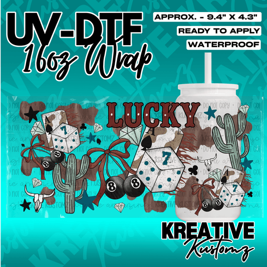 A western-themed UV DTF adhesive wrap for a 16oz glass can featuring dice, cacti, and cow print.