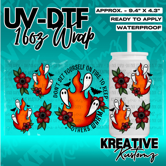 A UV DTF adhesive wrap for 16oz glass cans featuring ghosts, flames, and flowers.