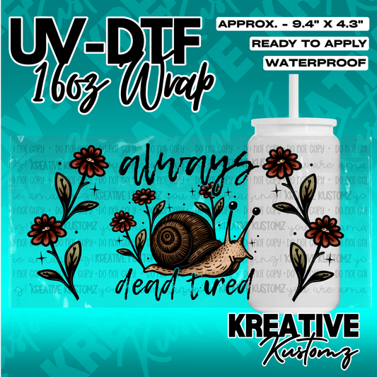 A UV DTF cup wrap featuring a snail and floral design with the text always dead tired.