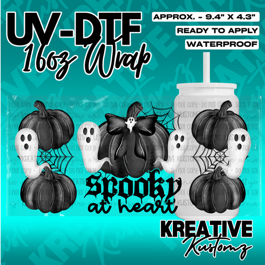 A UV DTF adhesive wrap for a 16oz glass cup featuring black pumpkins, white ghosts, and spiderwebs.