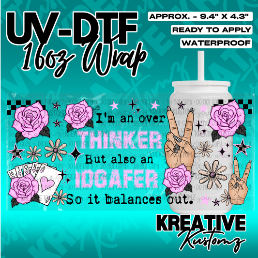 A UV DTF cup wrap featuring pink roses, playing cards, and text on a teal background.