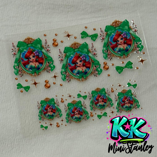 A sheet of UV DTF adhesive wraps featuring Ariel in ornate frames with green bows and bubbles.