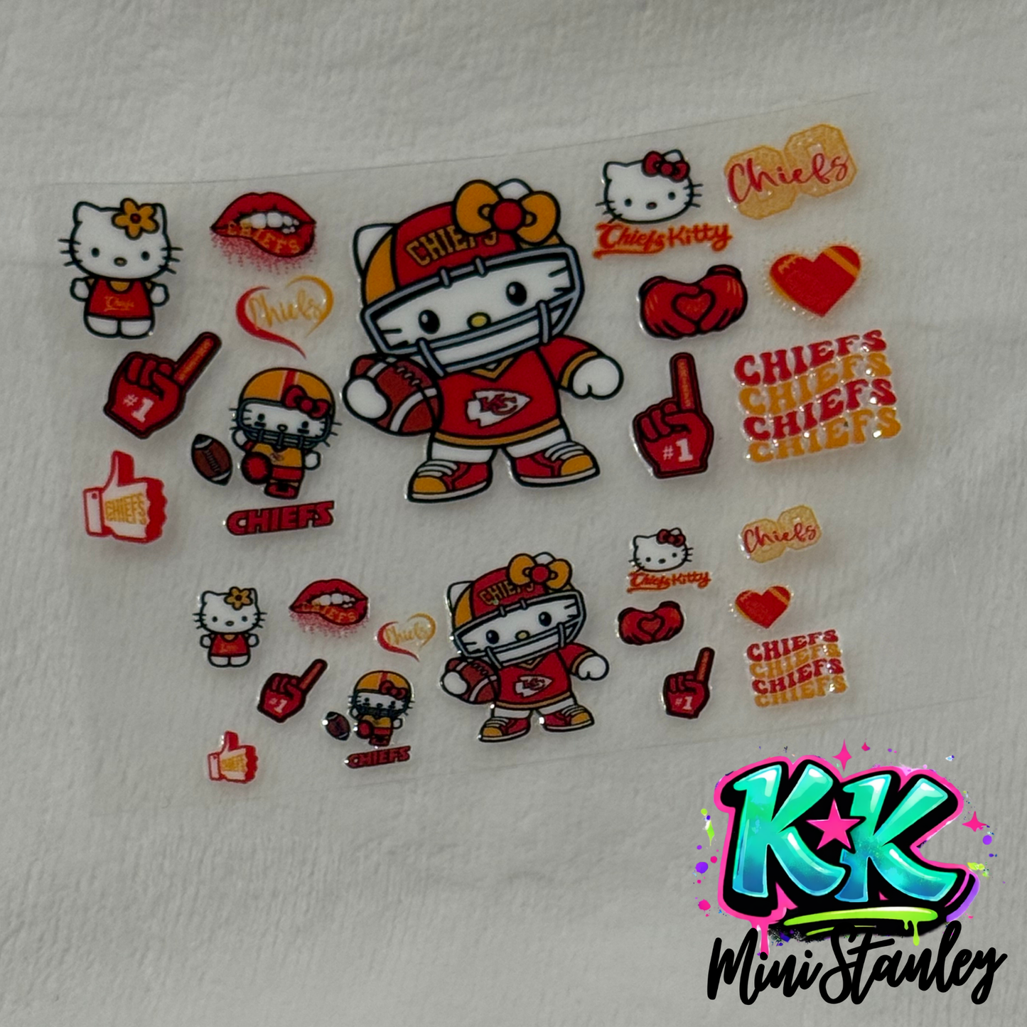 A sheet of Kansas City Chiefs themed Hello Kitty UV DTF adhesive decals for mini cups.
