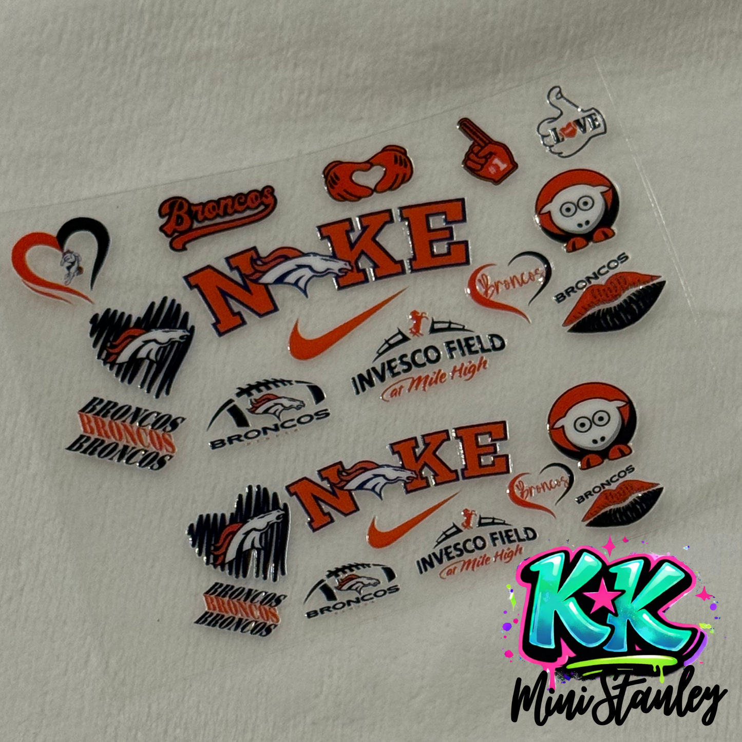 A sheet of Denver Broncos themed UV DTF adhesive decals for mini keychain cups.