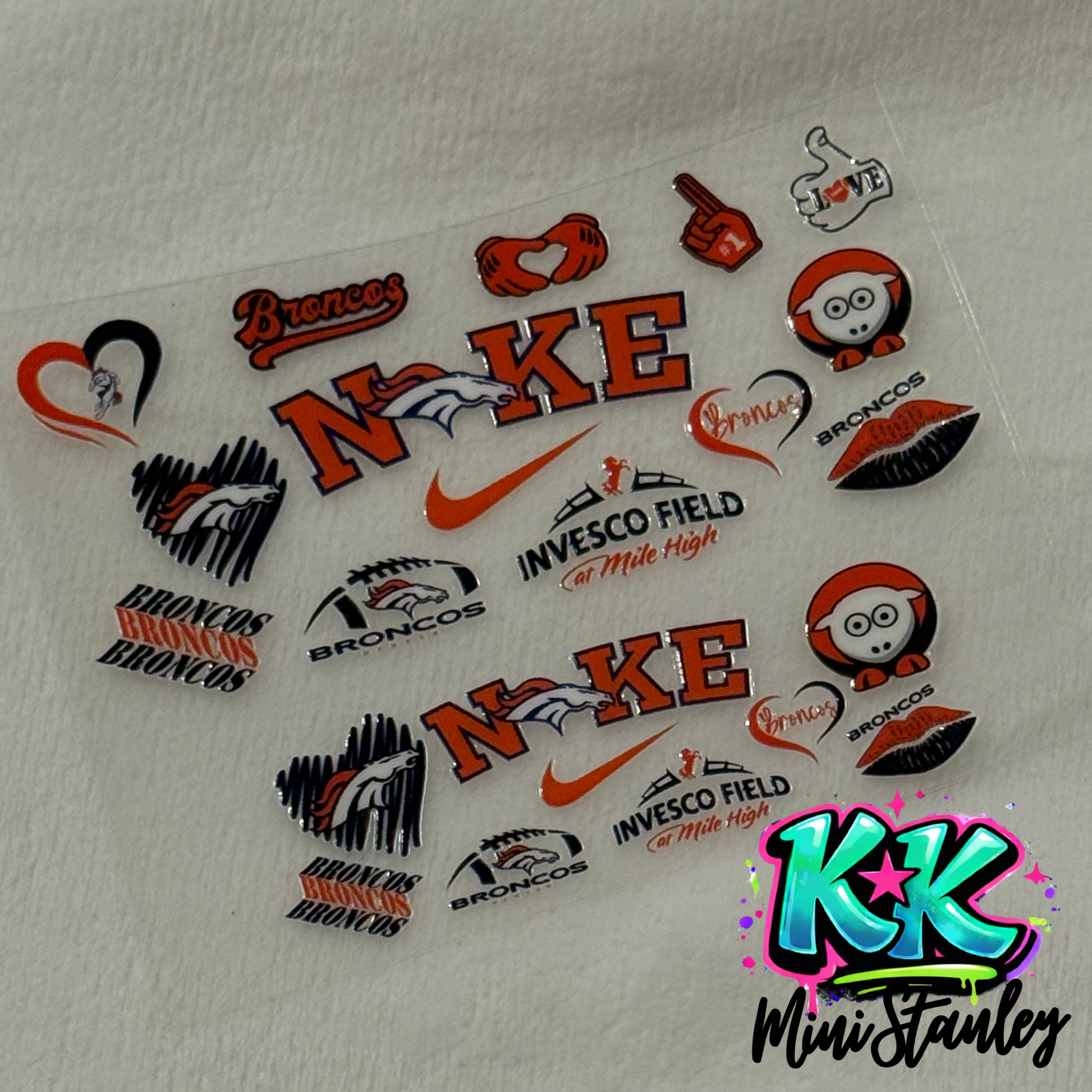 A sheet of Denver Broncos themed UV DTF adhesive decals for mini keychain cups.