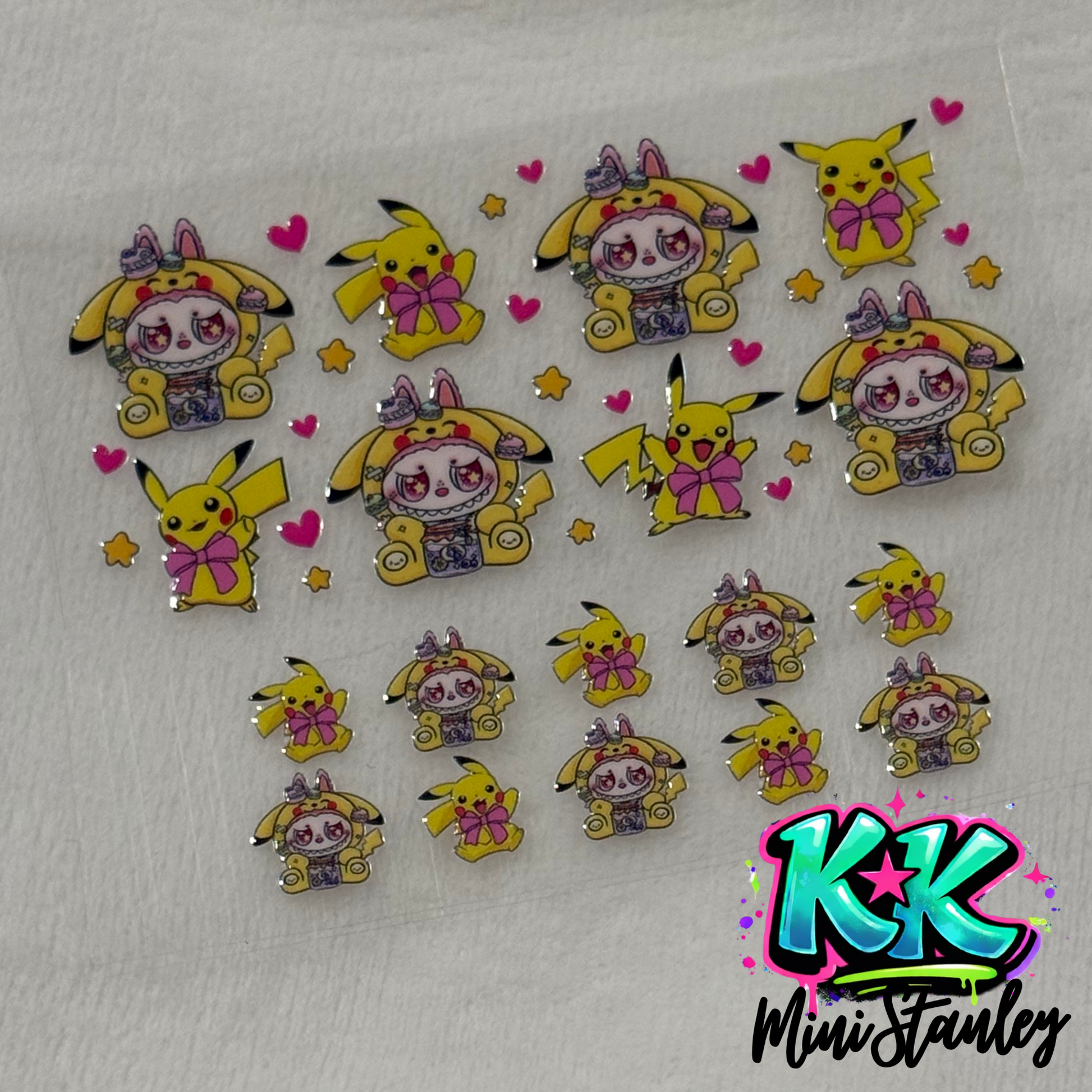 A sheet of UV DTF adhesive decals featuring Pikachu and character-themed designs.
