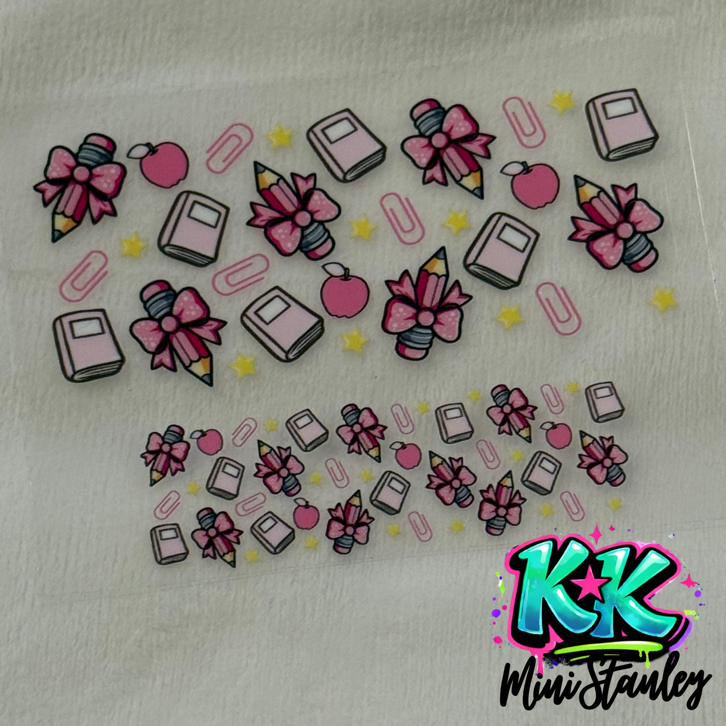 A UV DTF adhesive wrap featuring a school-themed pattern of pink pencils, books, and apples.