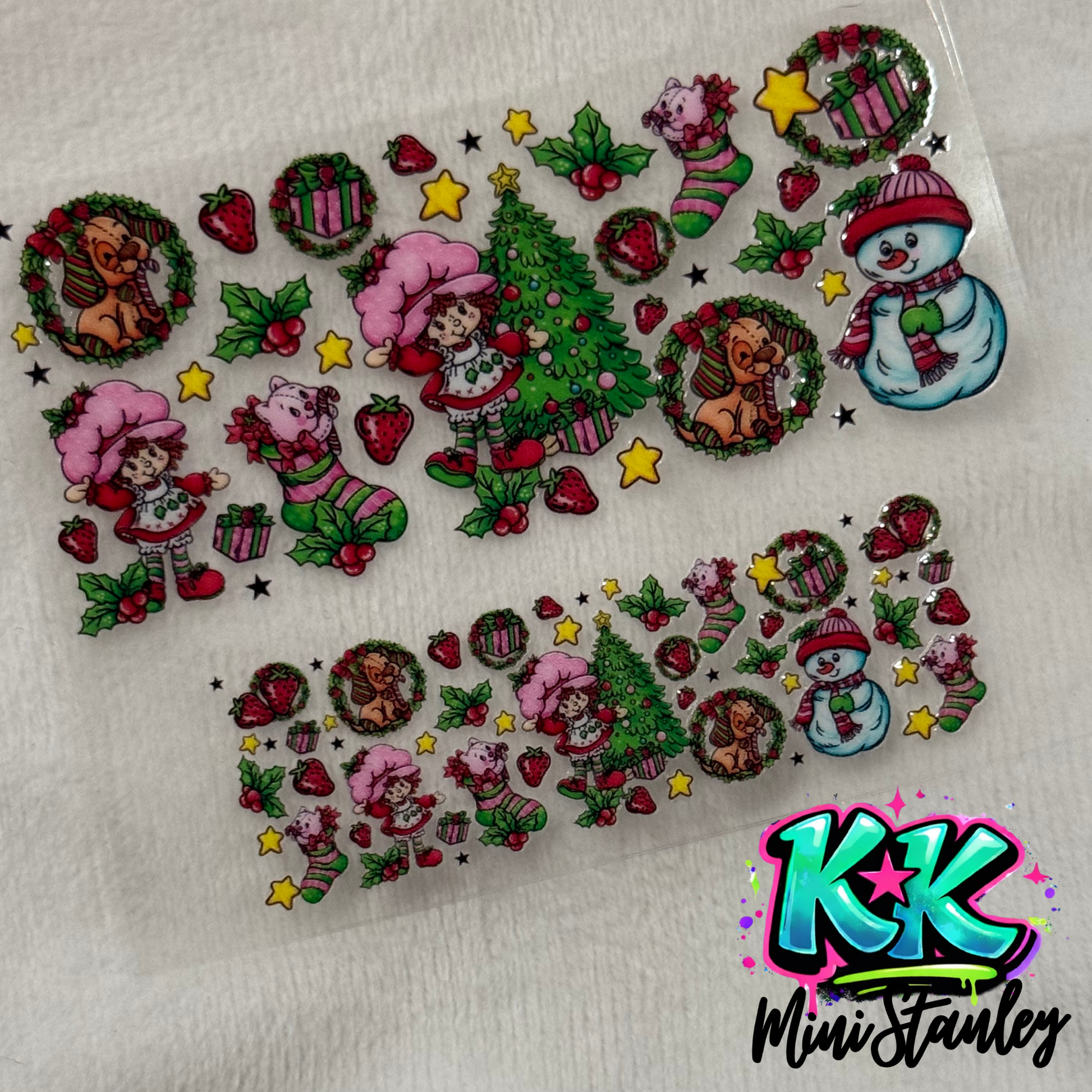 Two sheets of Strawberry Shortcake themed UV DTF adhesive decals for mini keychains.