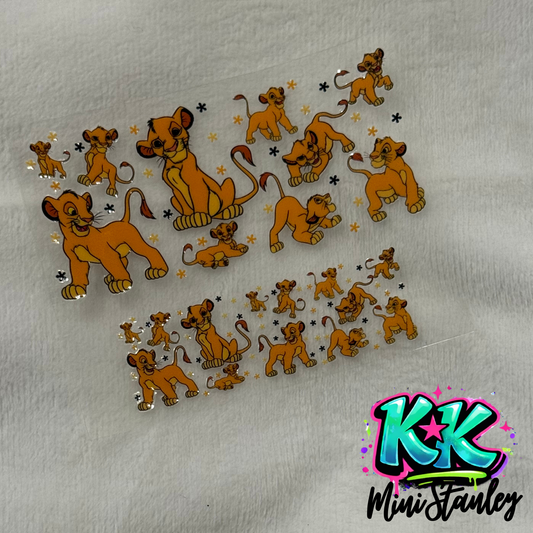 Two sheets of UV DTF adhesive transfers featuring Simba from The Lion King and small flowers.