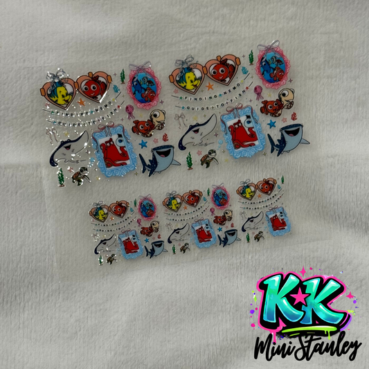 Two sheets of Finding Nemo themed UV DTF adhesive transfers for mini keychains.