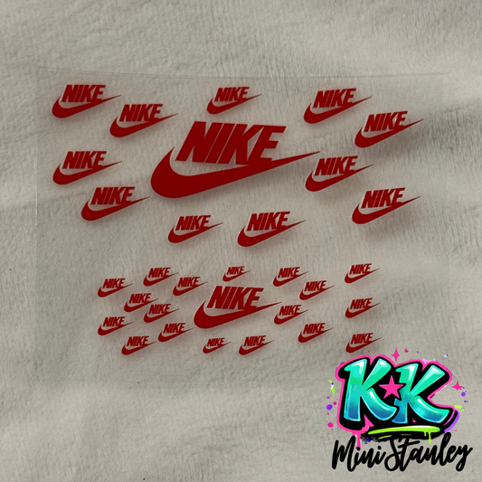 A clear sheet featuring multiple red Nike logo decals in various sizes for mini cup keychains.