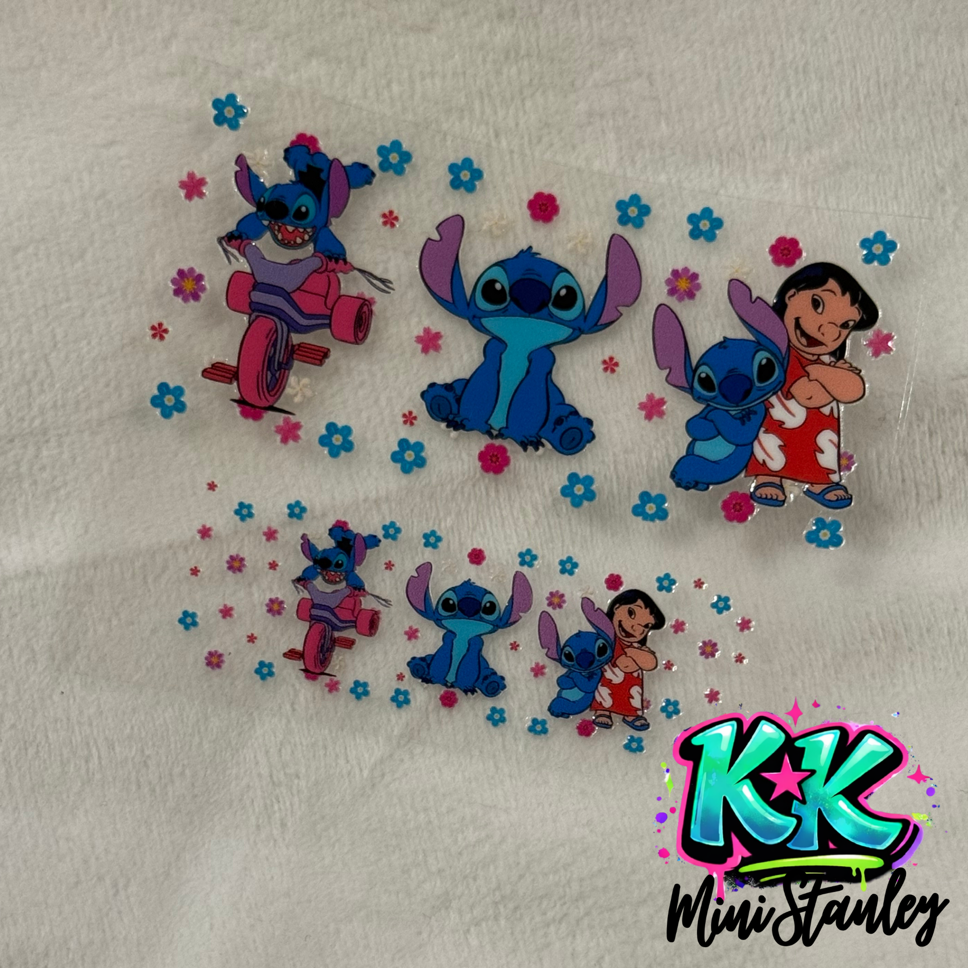 Two UV DTF adhesive wraps featuring Stitch and Lilo with floral accents for mini keychains.