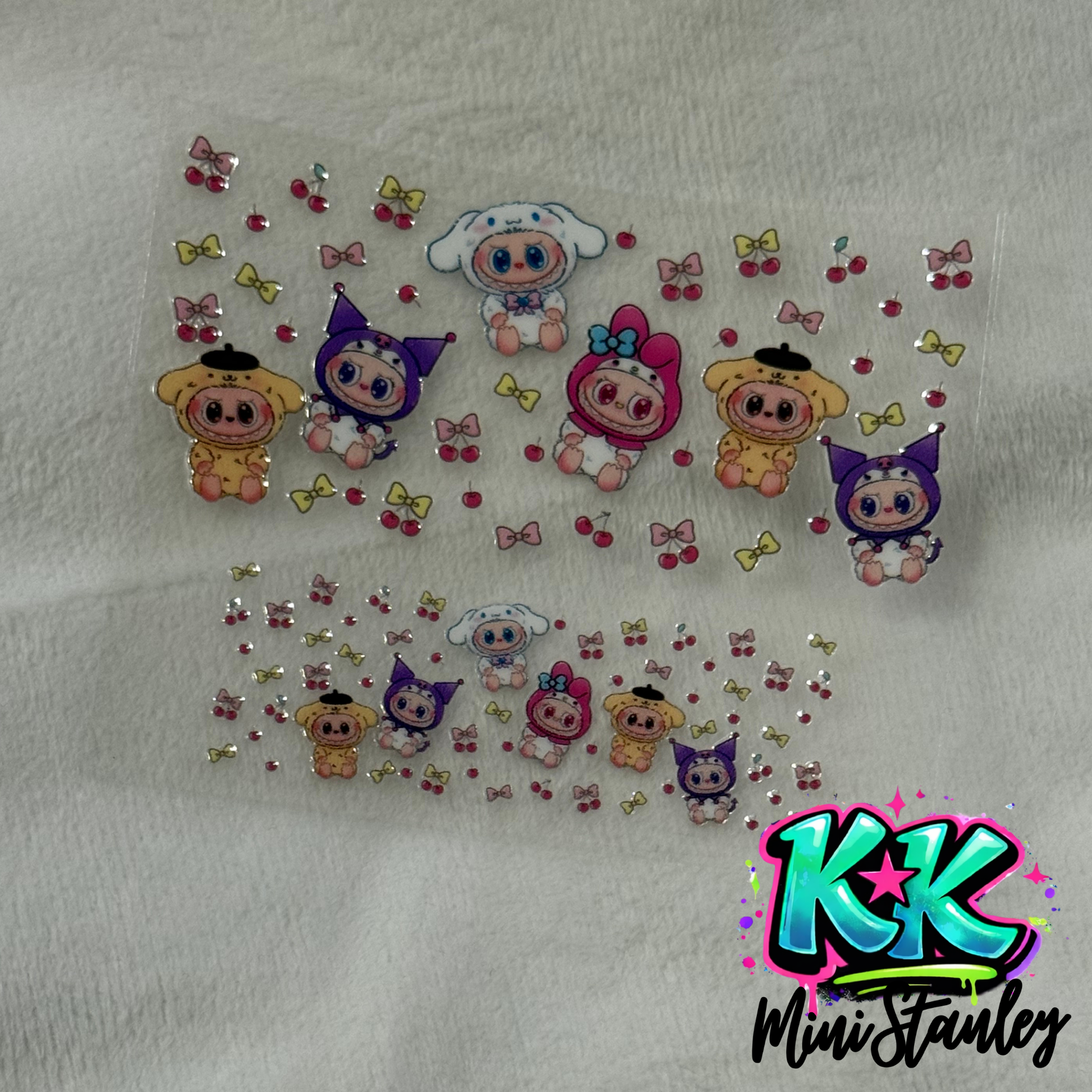 Two sheets of UV DTF adhesive decals featuring Sanrio characters, cherries, and bows.