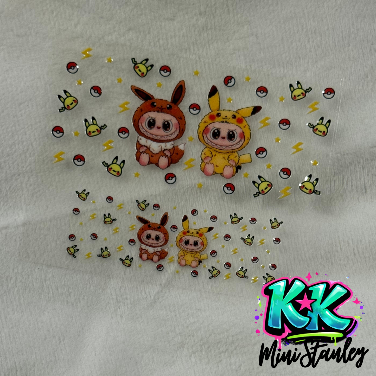 Two UV DTF adhesive decal sheets featuring cartoon characters in Eevee and Pikachu costumes.