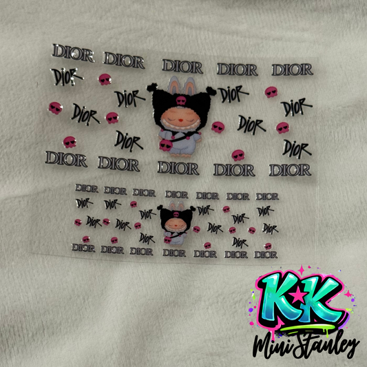A UV DTF adhesive decal sheet featuring Dior logos, pink skulls, and a cartoon character.